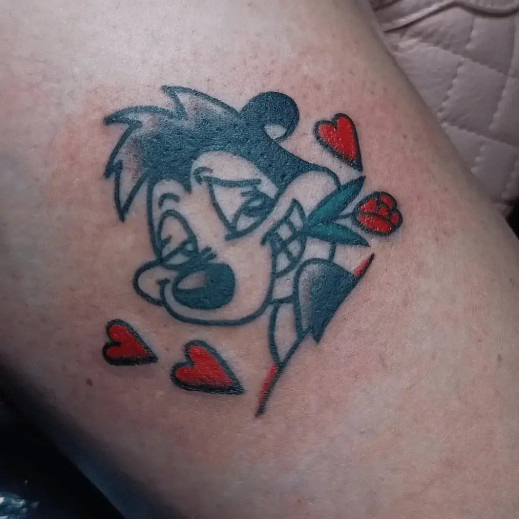 Small full-color Pepé Le Pew tattoo idea