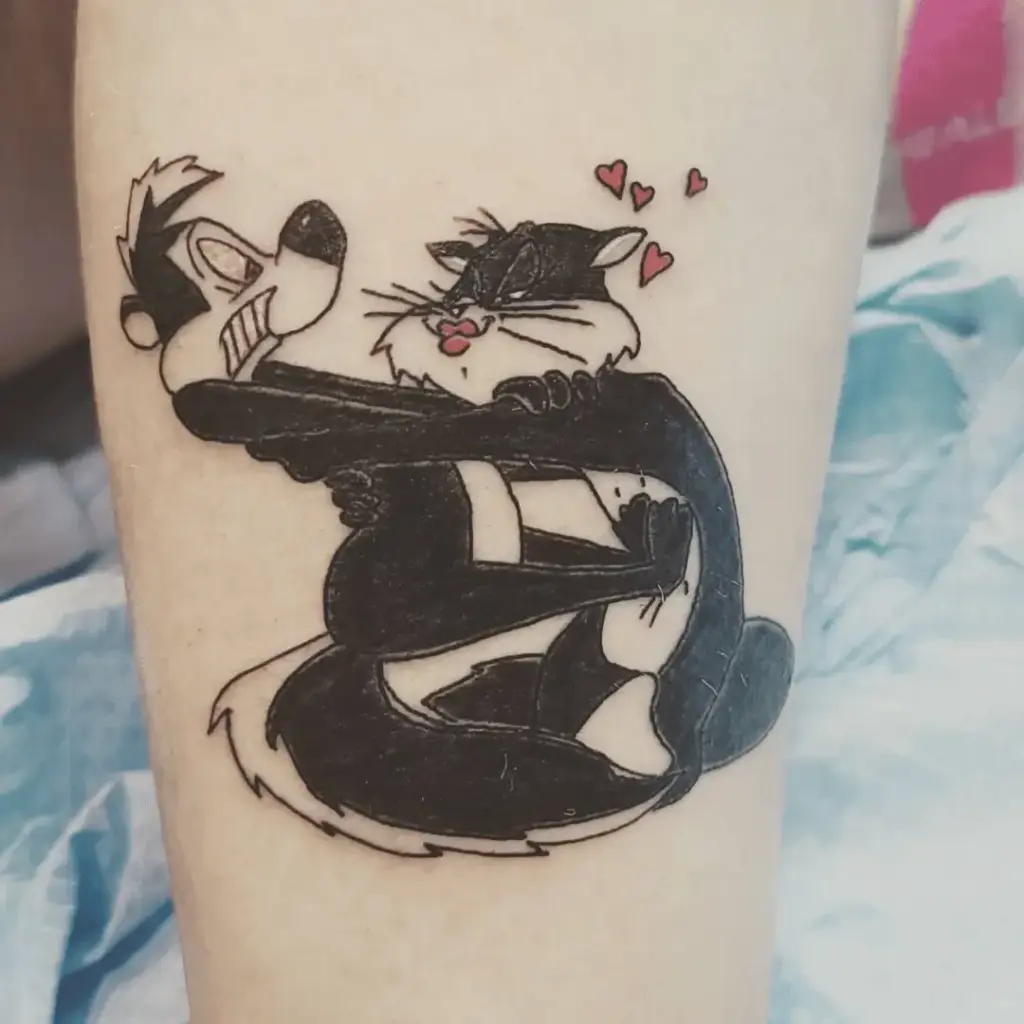 Colorful Pepe Le Pew lower-leg tattoo with cartoon shading