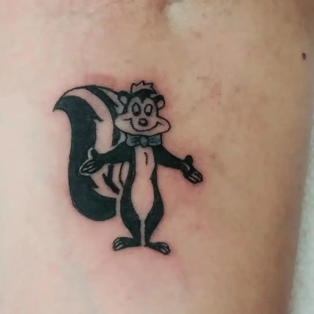 Small Pepé Le Pew character tattoo with a simple background