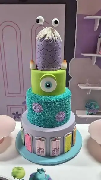 Mike Wazowski and Celia Mae inspired cake with green and purple character details
