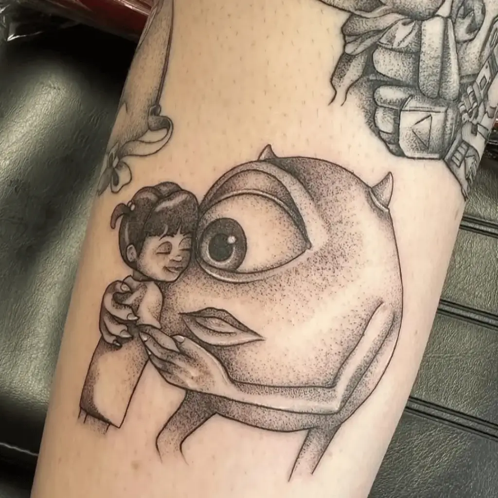 Small Mike Wazowski and Boo tattoo inspired by Monsters Inc