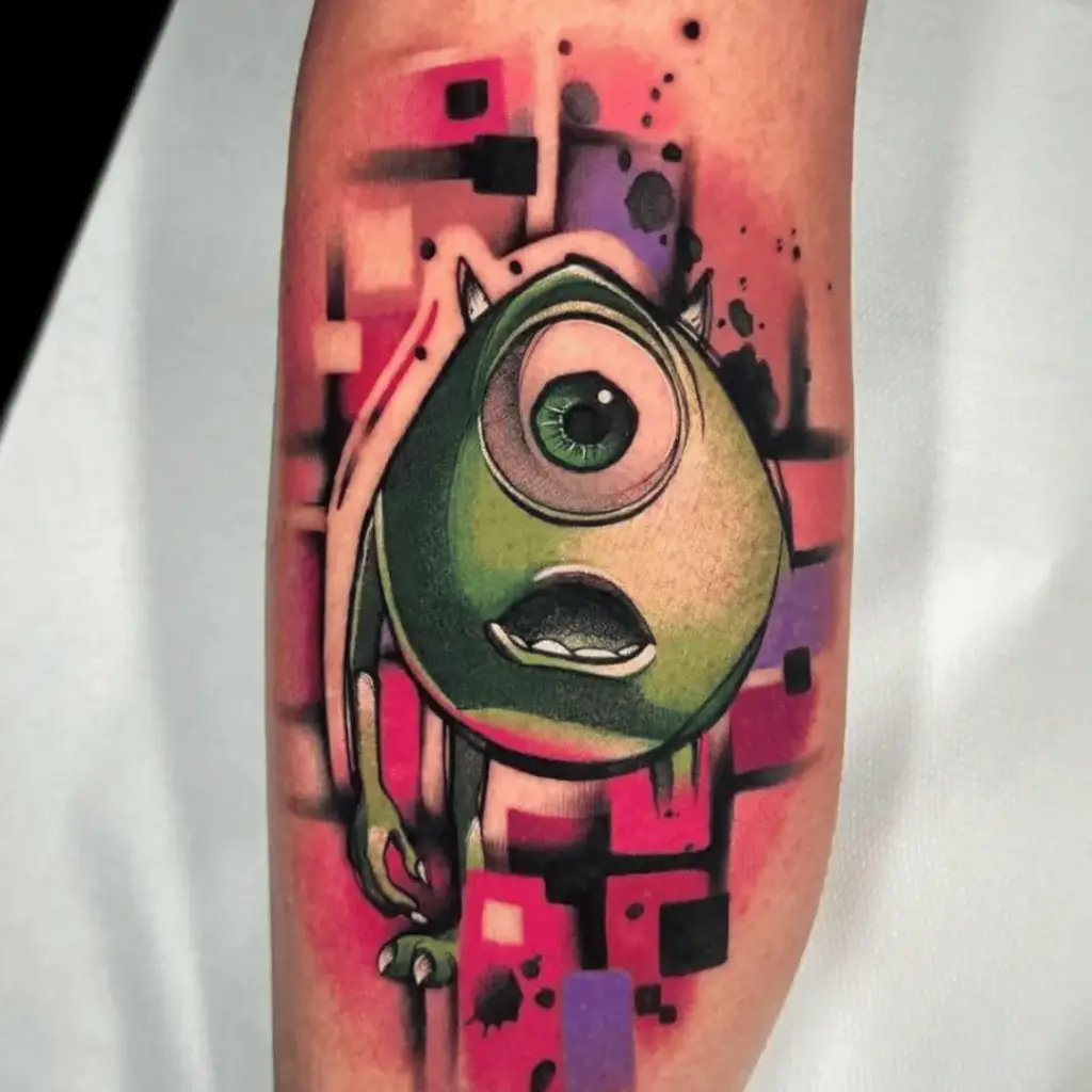Colorful Mike Wazowski tattoo with a bright decorative background