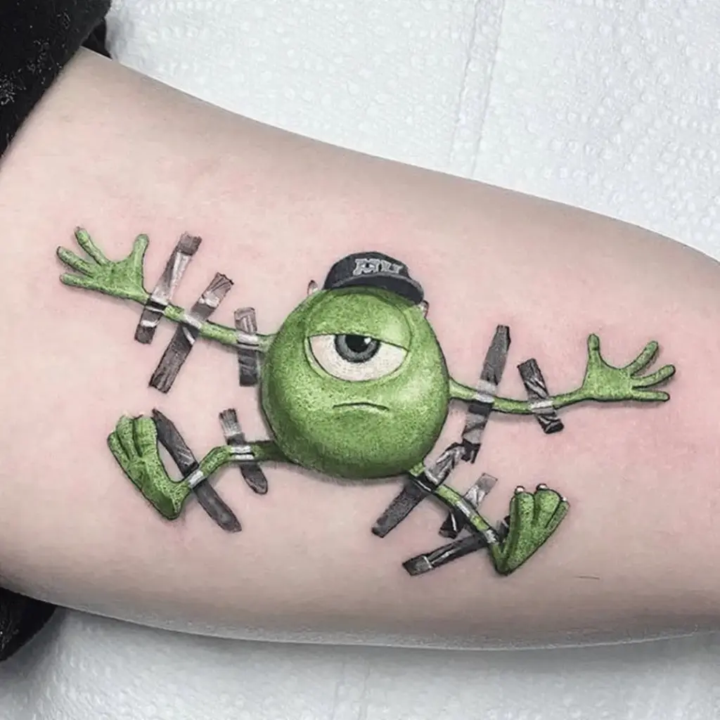 Full-color Mike Wazowski cartoon tattoo on the arm