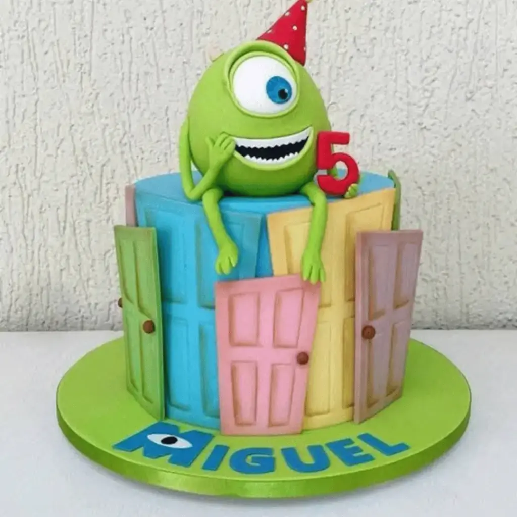 Green Mike Wazowski birthday cake decorated with his face and large single eye