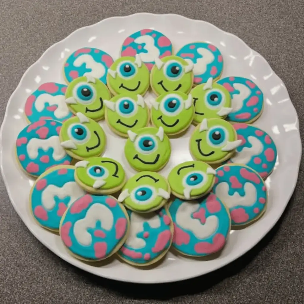 Round Mike Wazowski sugar cookies with green icing and one large eye