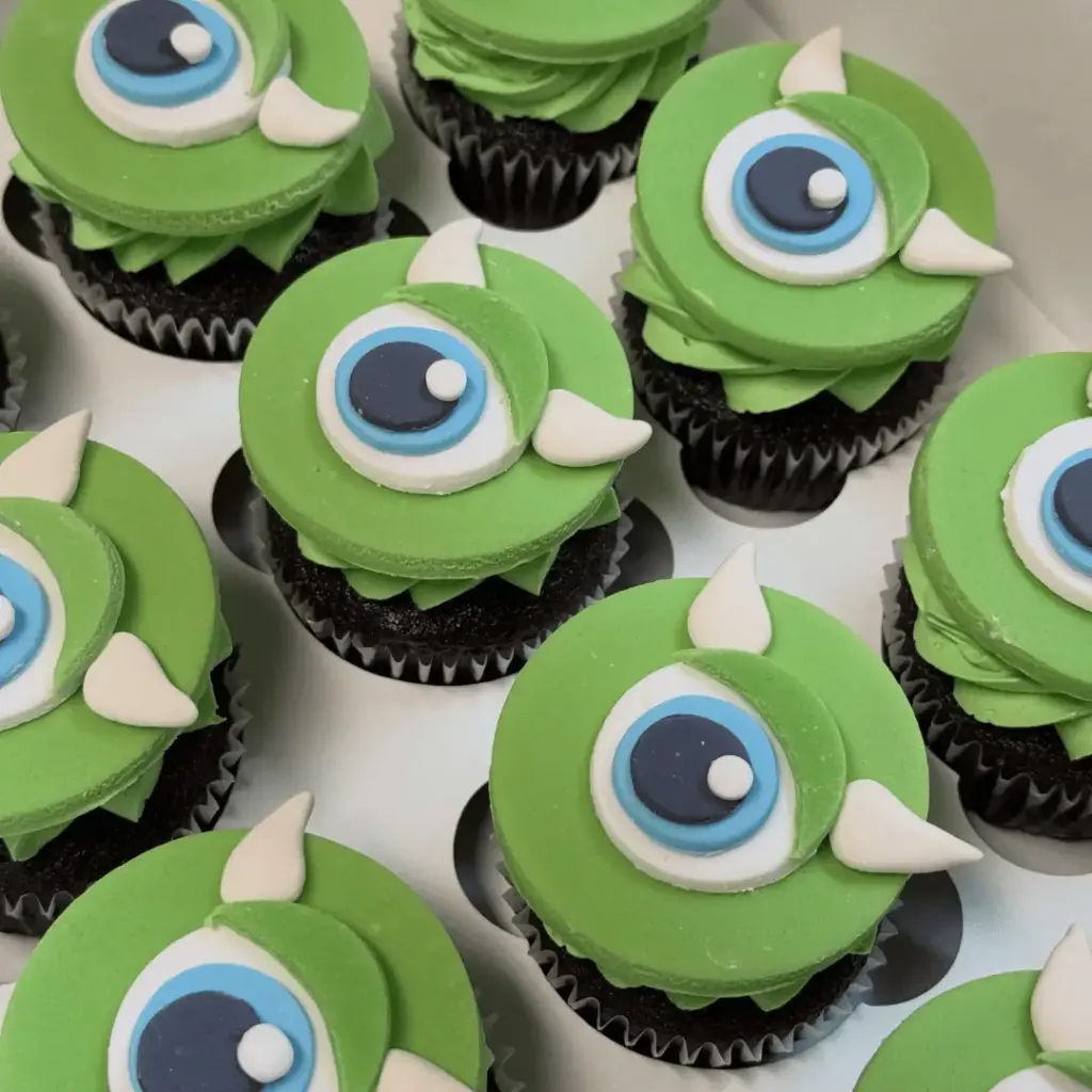 Mike Wazowski cupcakes with green frosting, one large eye and small horns