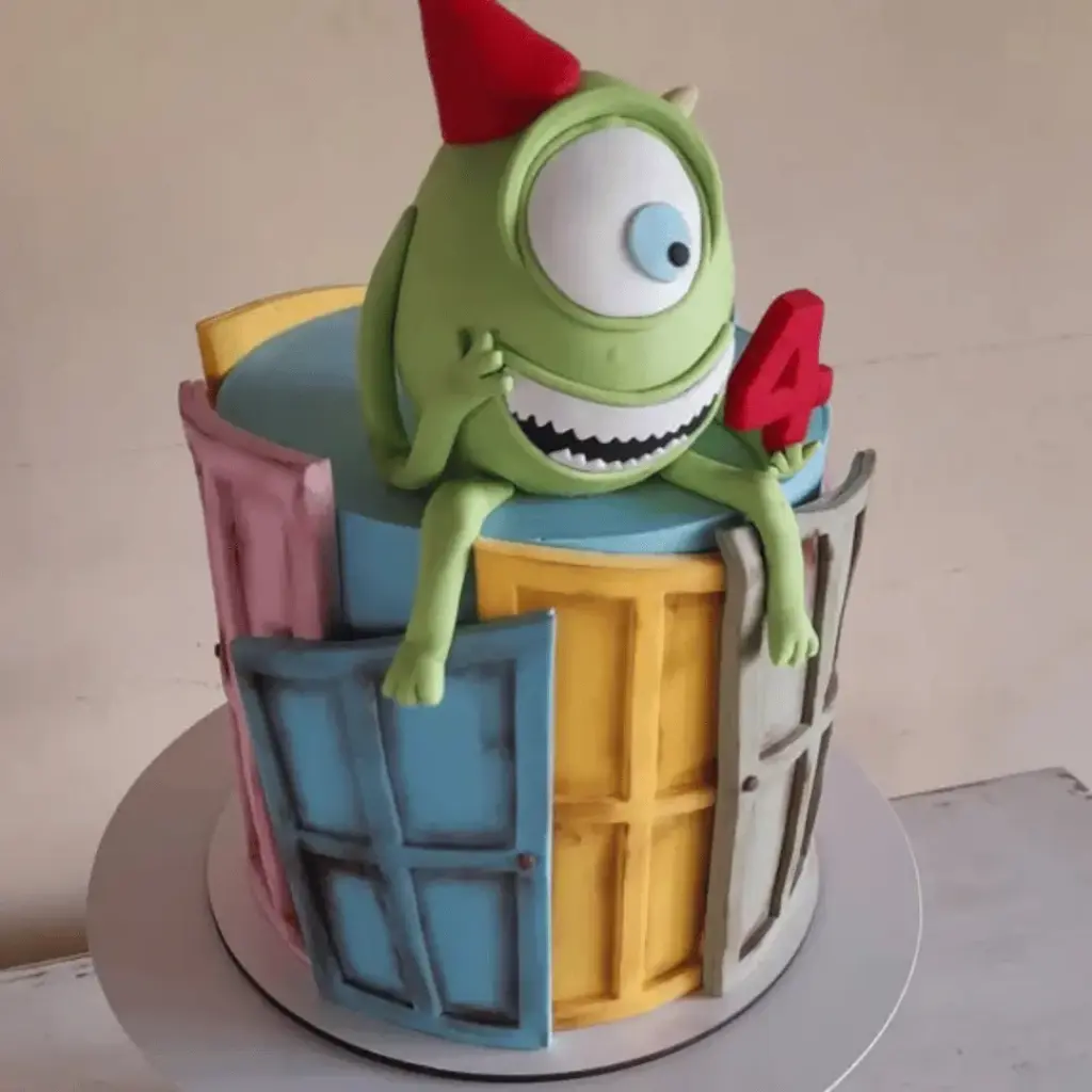 Round Mike Wazowski fondant cake with a large blue eye and smiling mouth