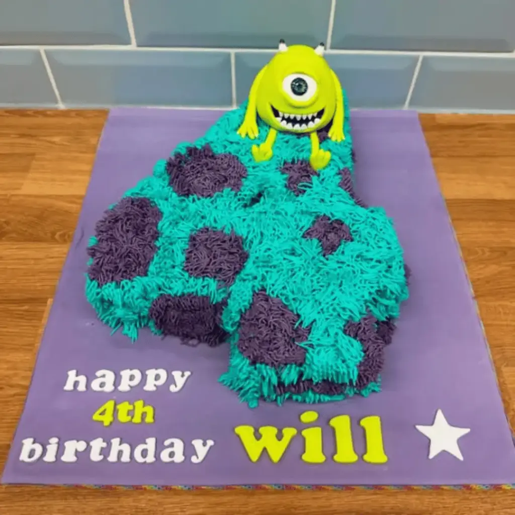 Number four Monsters Inc cake with blue Sulley frosting and a Mike Wazowski topper