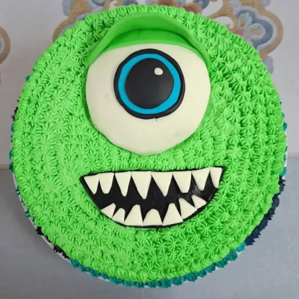 Mike Wazowski cake covered with piped green icing and a large central eye