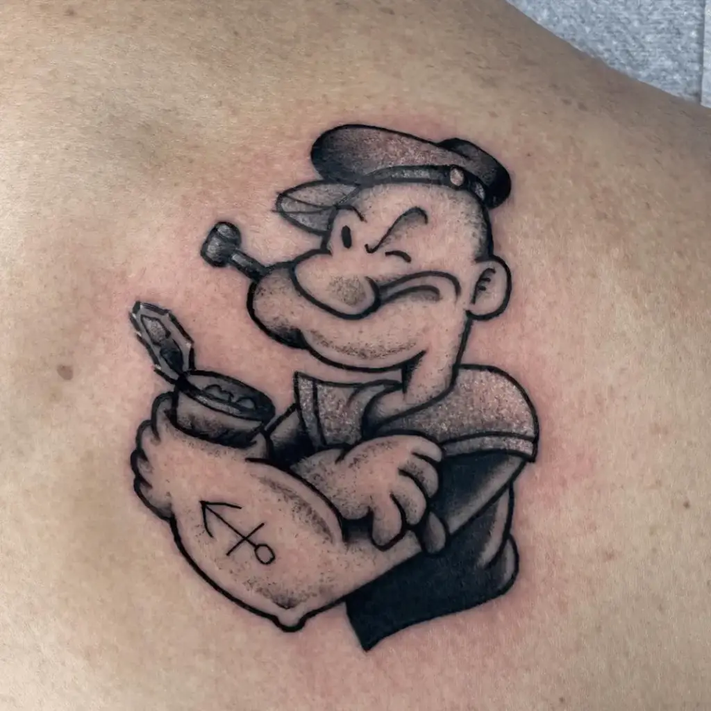 Small Popeye character tattoo on the upper back